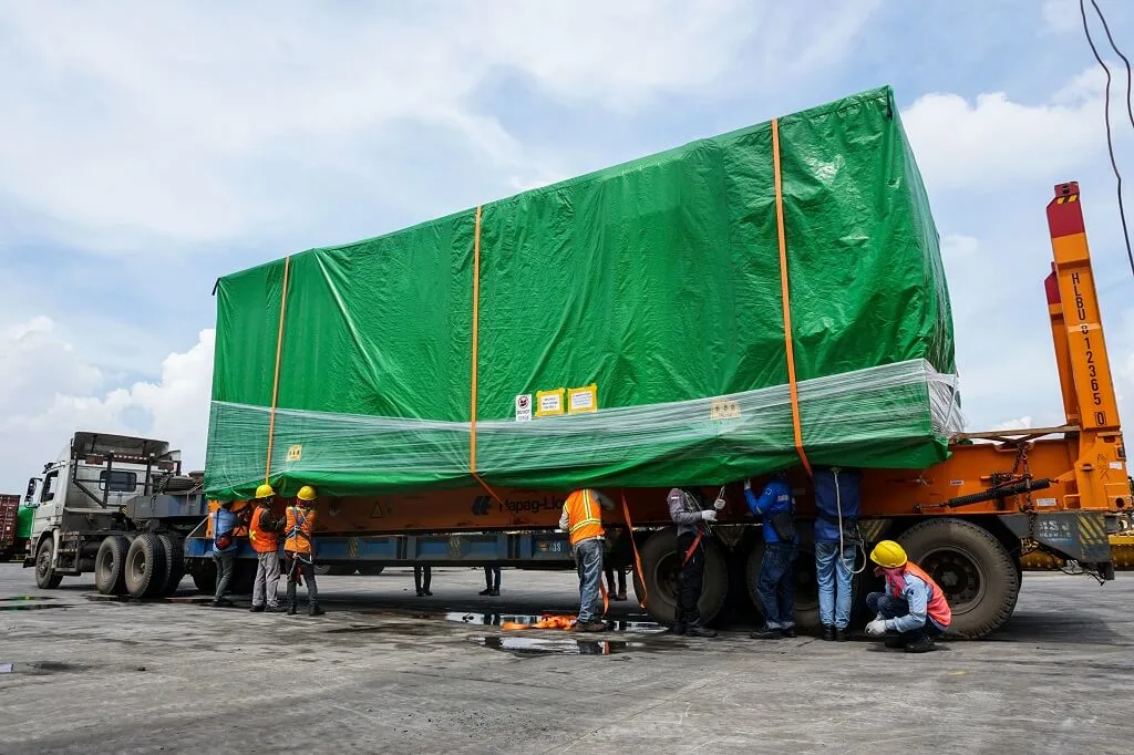 Professionals preparing a cargo truck for project cargo handling services, ensuring safe loading and efficient logistics operations.