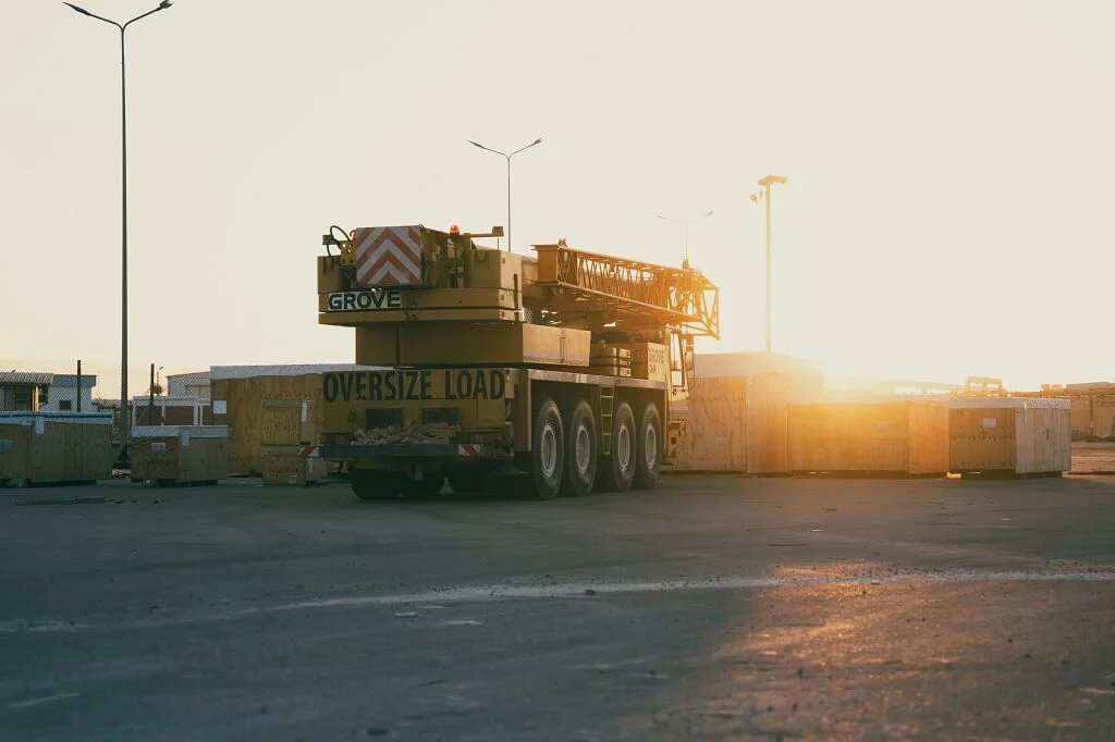 A construction crane at a Libyan site during sunset, emphasizing industry and development.